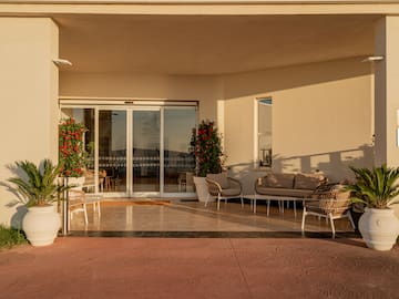 a patio with chairs and a couch