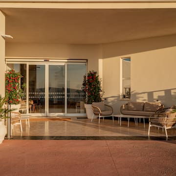 a patio with chairs and a couch