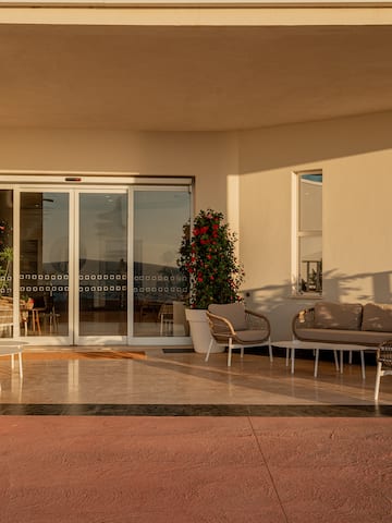 a patio with chairs and a couch