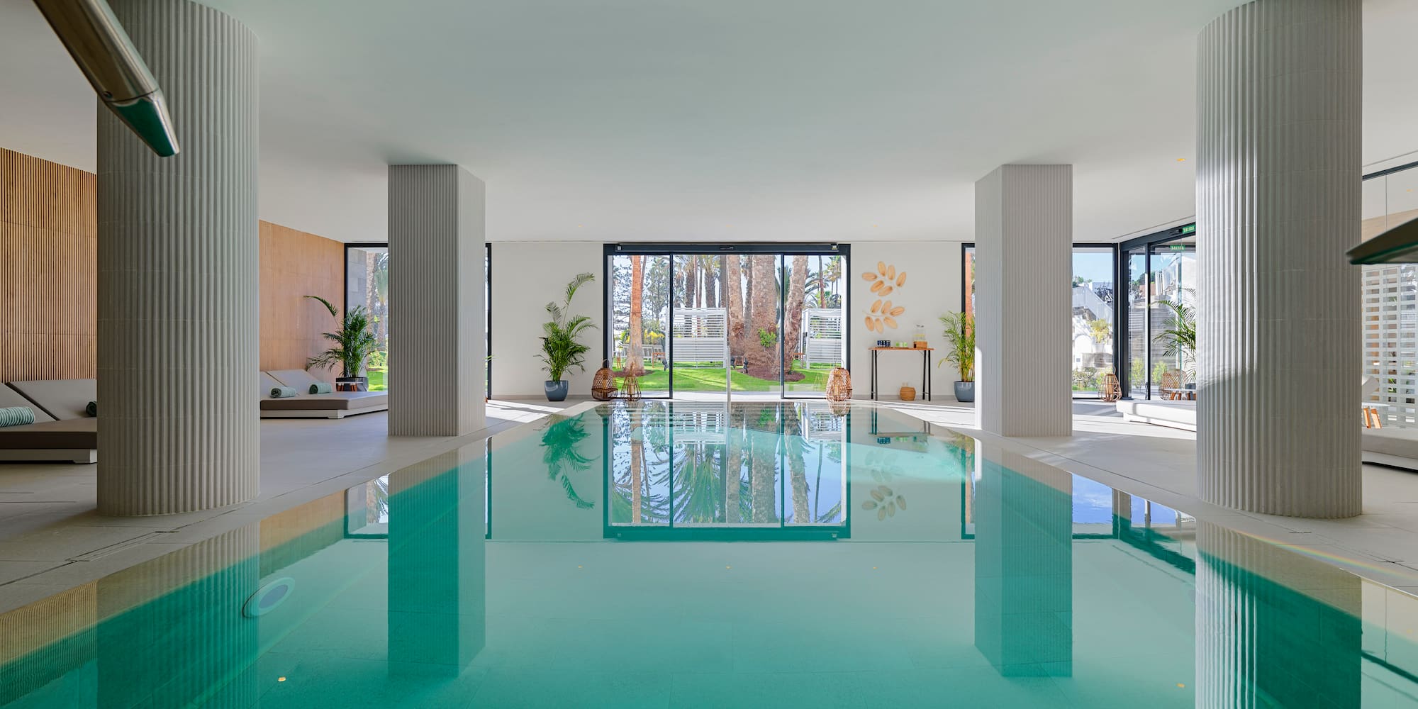a indoor pool with a large glass door