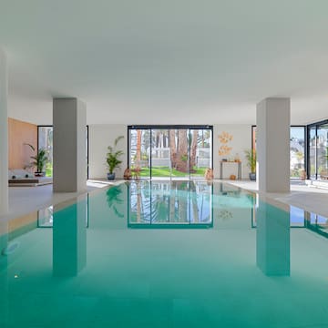 a indoor pool with a large glass door