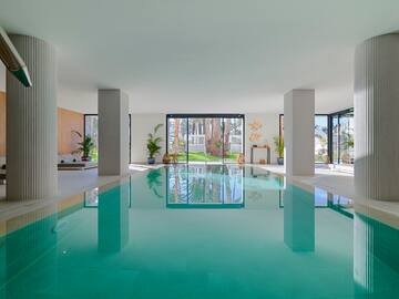 a indoor pool with a large glass door
