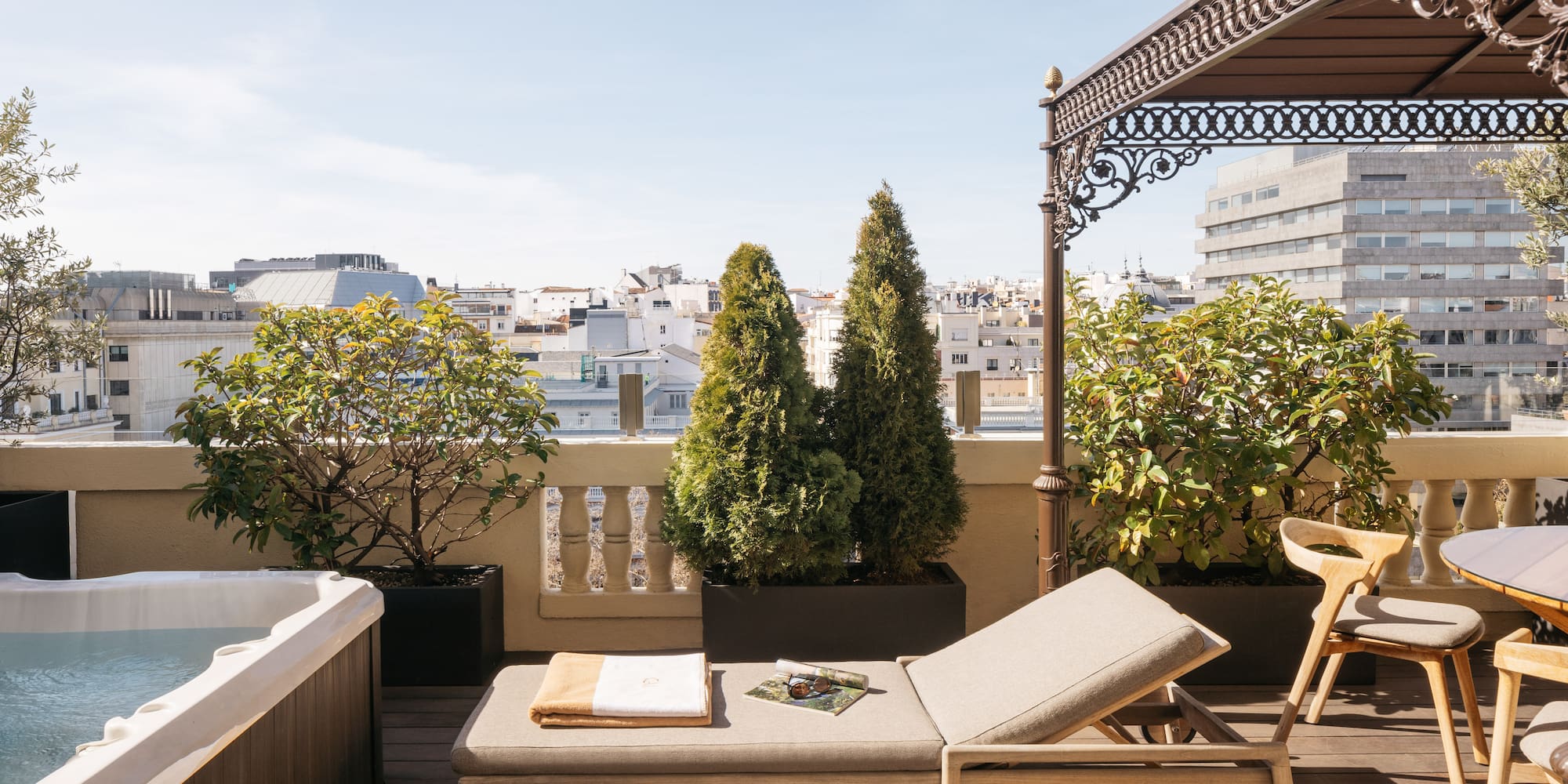 a deck with a hot tub and a lounge chair.