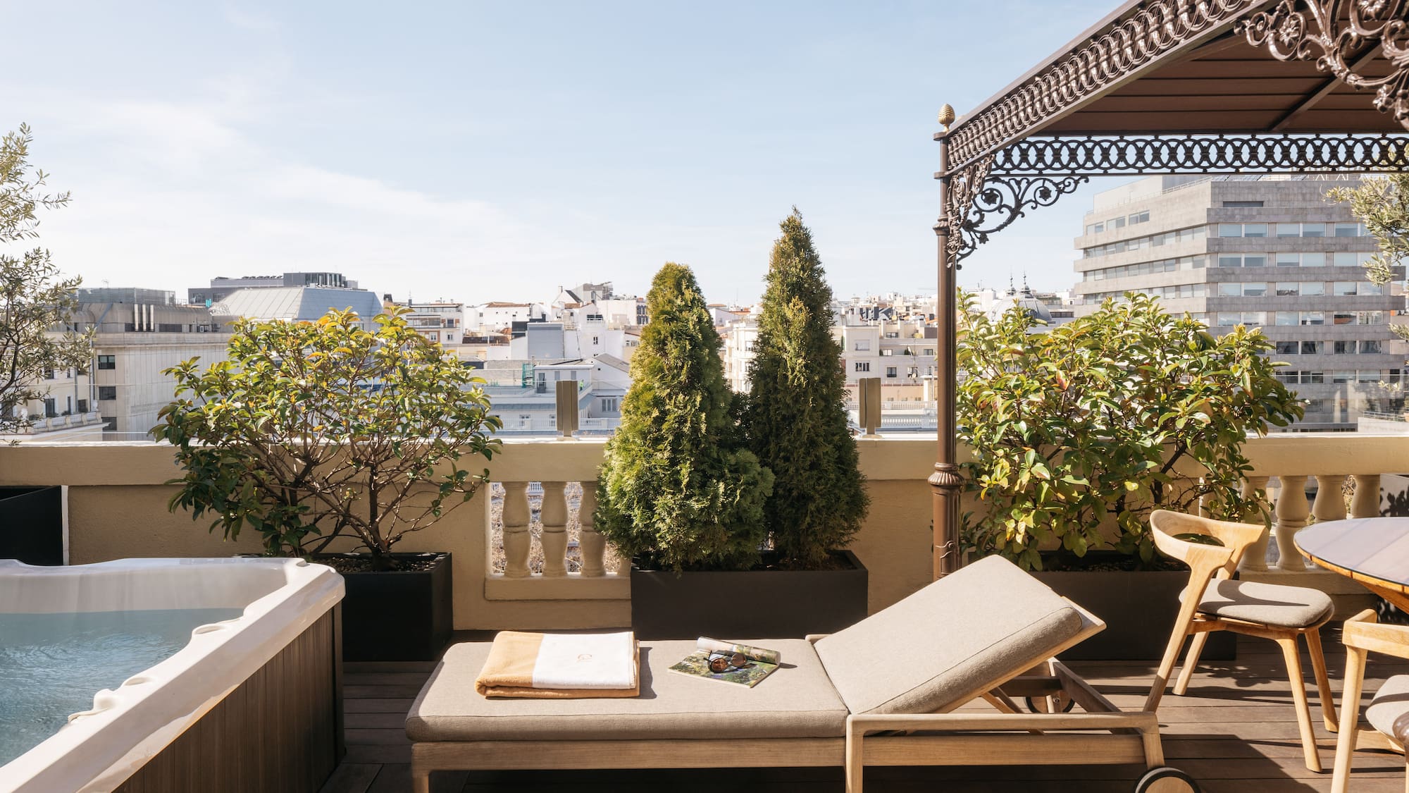 a deck with a hot tub and a lounge chair.