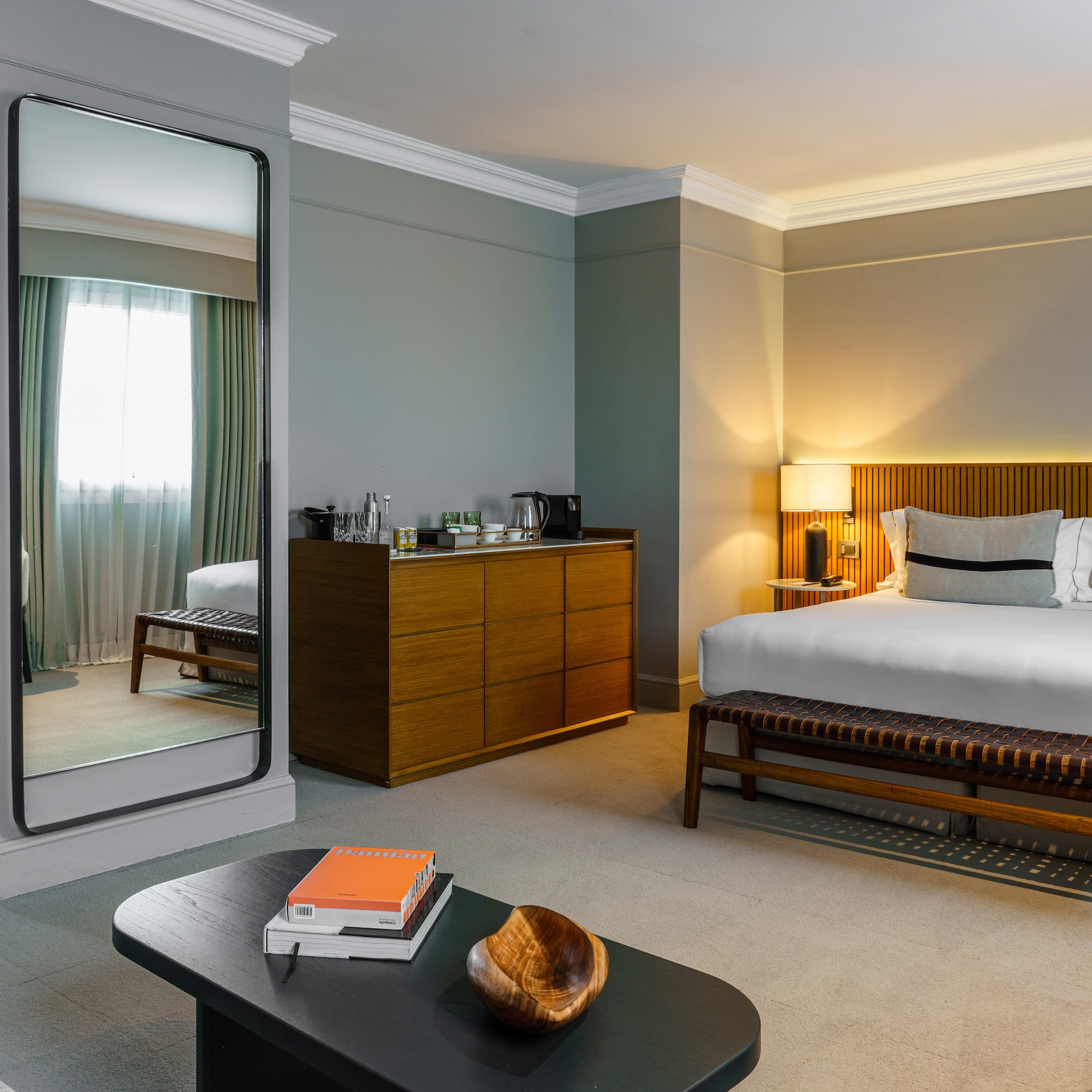 a bedroom with a mirror and a bed