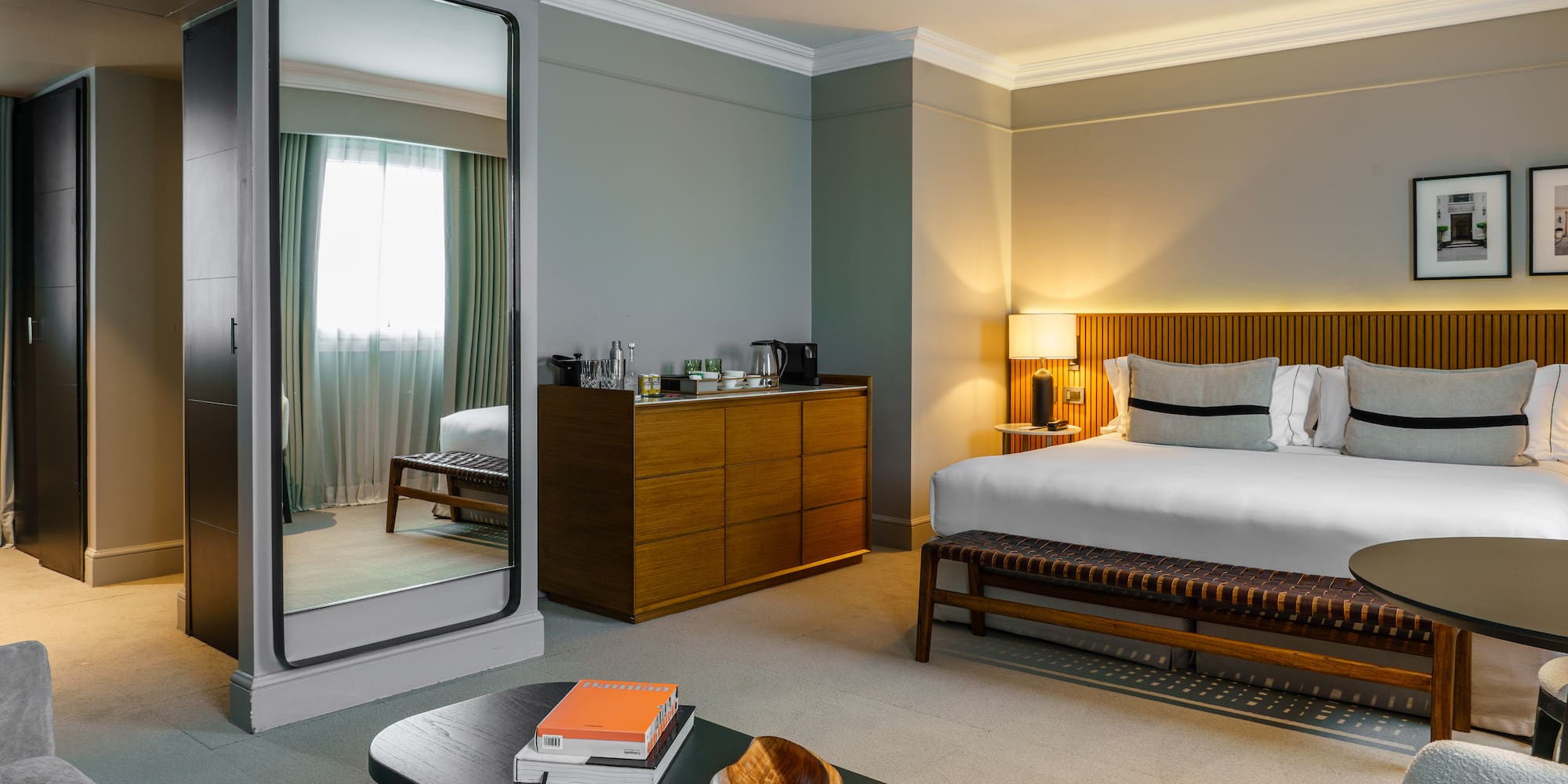 a bedroom with a mirror and a bed