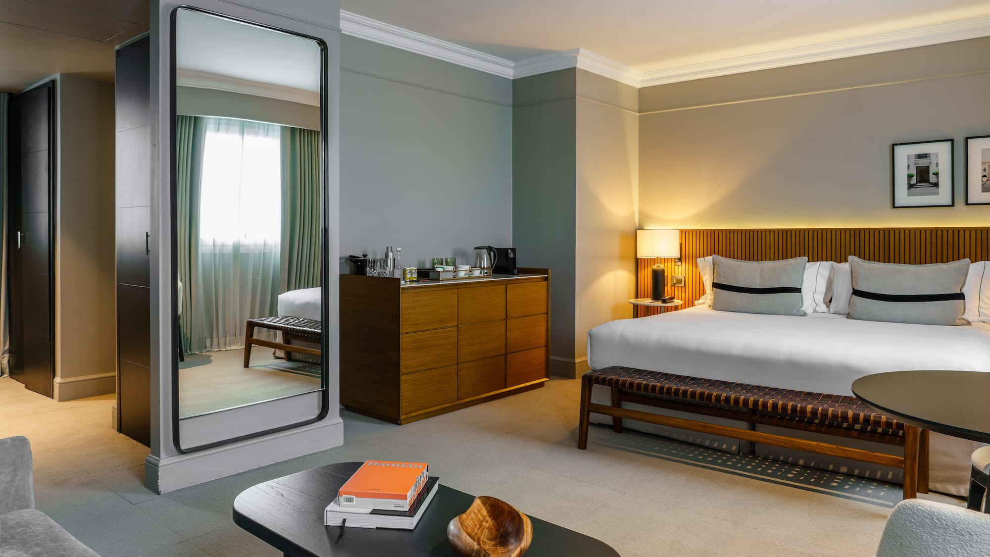 a bedroom with a mirror and a bed