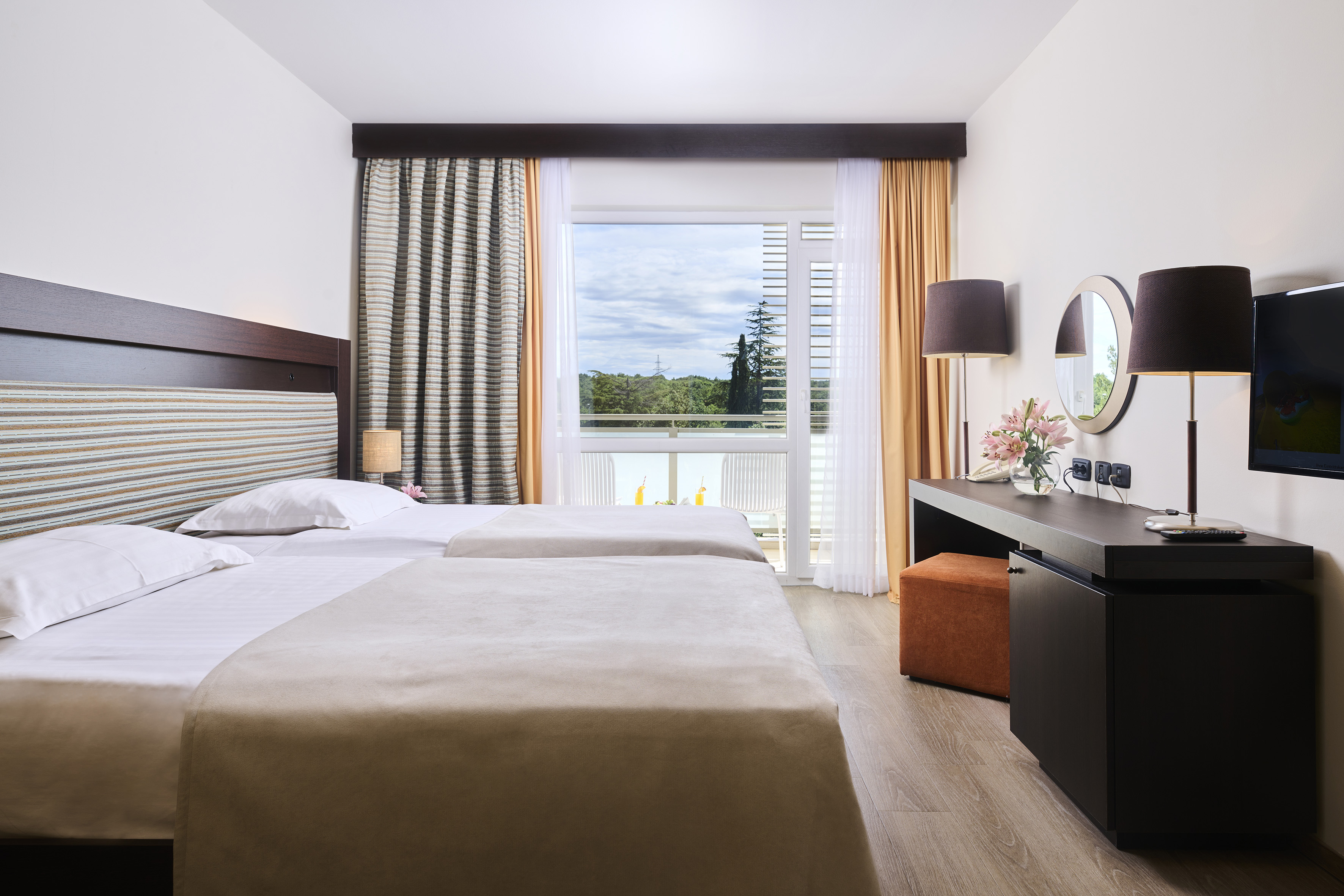 a room with two beds and a mirror