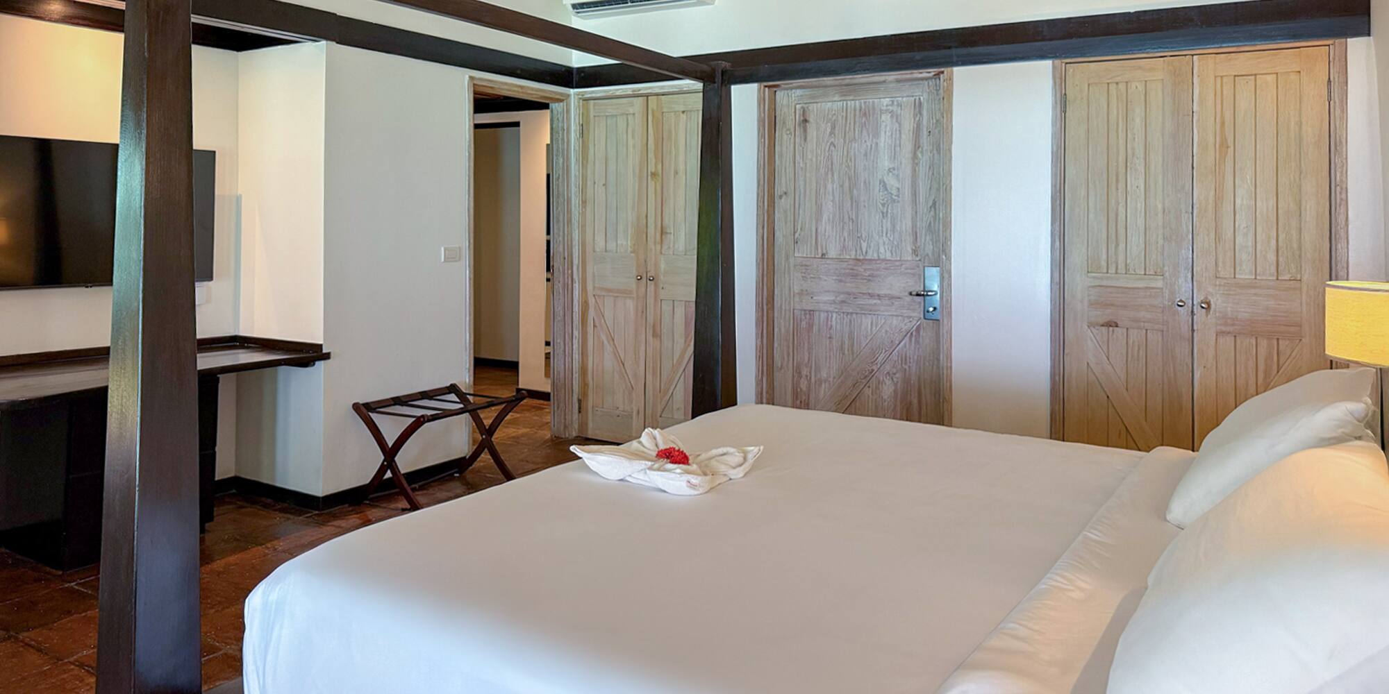 a bedroom with a bed and a television