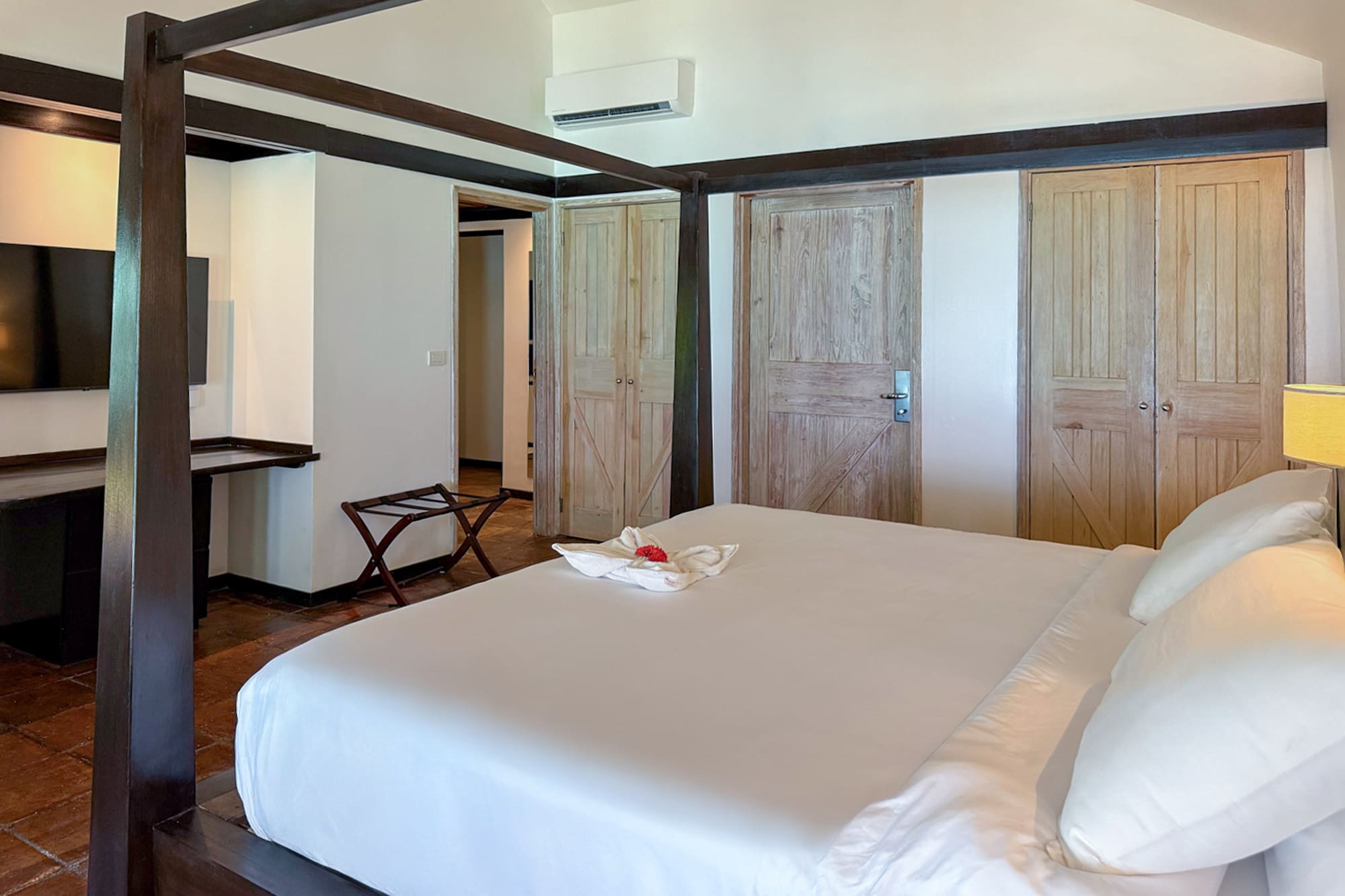 a bedroom with a bed and a television