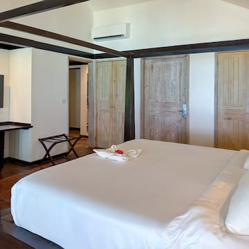 a bedroom with a bed and a television