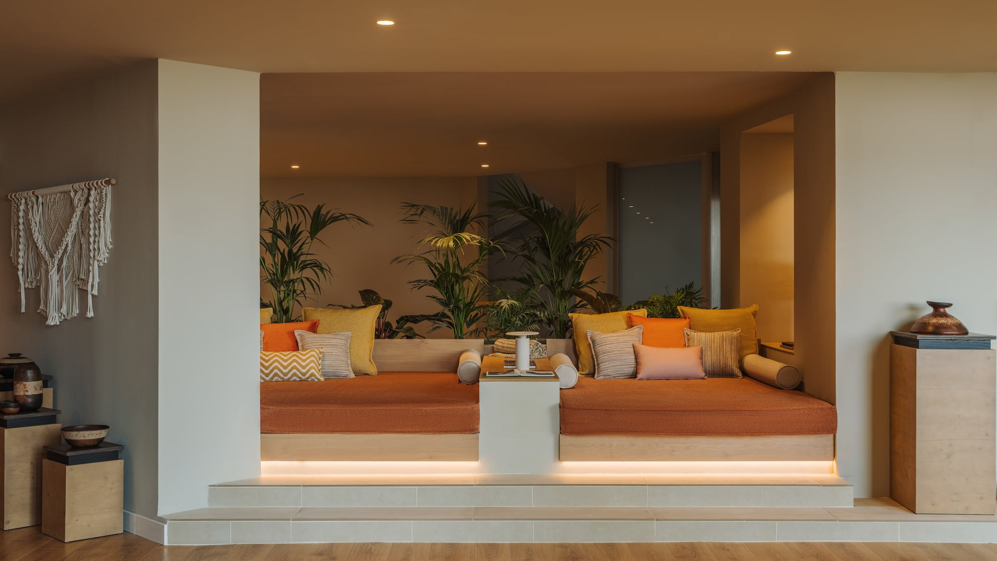 a room with a couch and plants