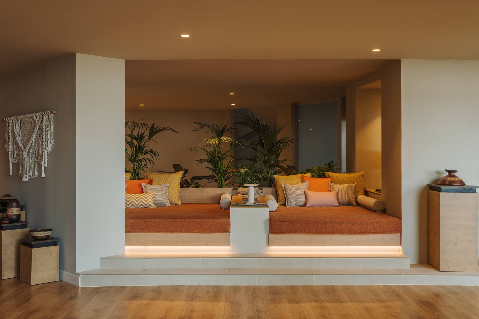 a room with a couch and plants