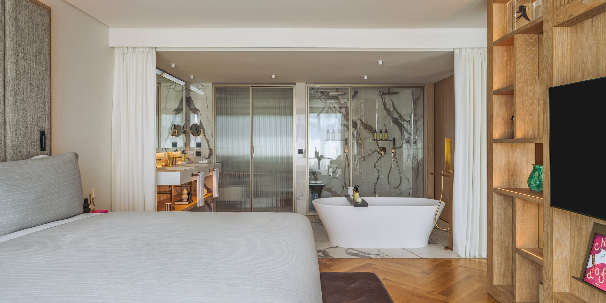 a bedroom with a bathtub and a bookcase