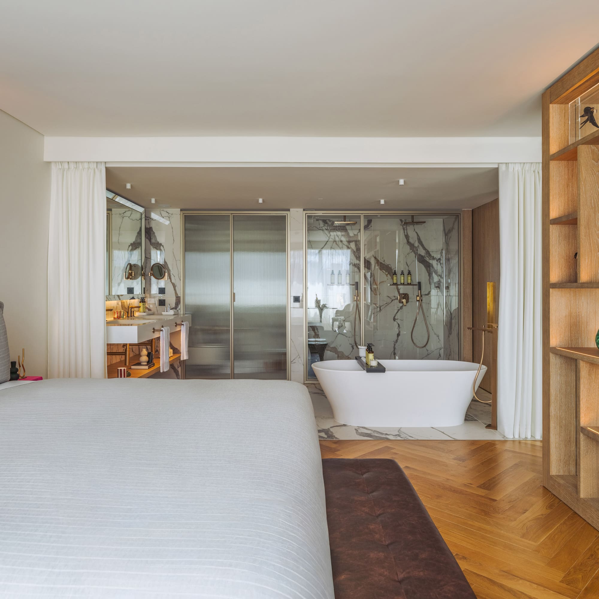 a bedroom with a bathtub and a bookcase