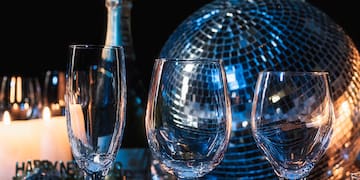 a group of wine glasses and a bottle of champagne