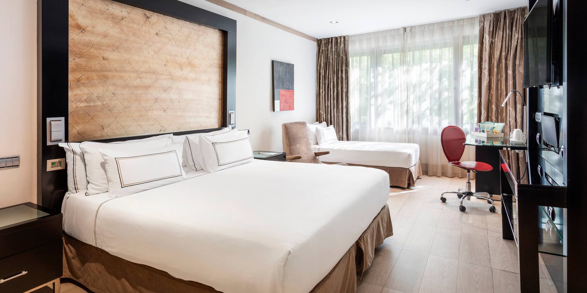 a room with two beds and a desk