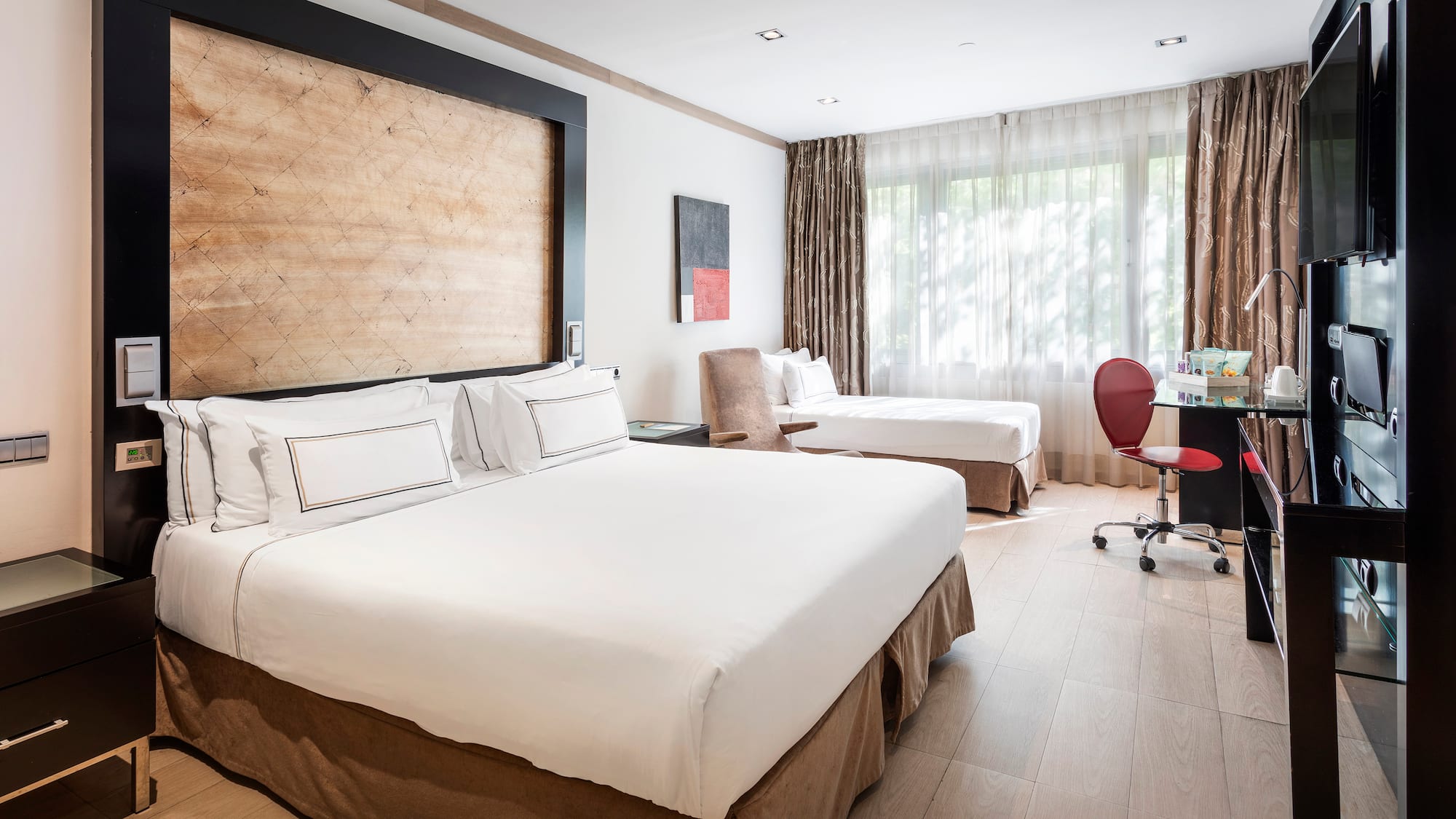 a room with two beds and a desk