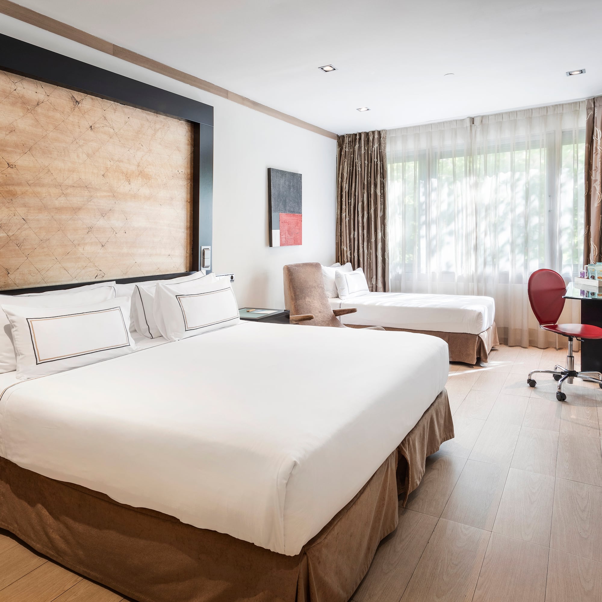 a room with two beds and a desk