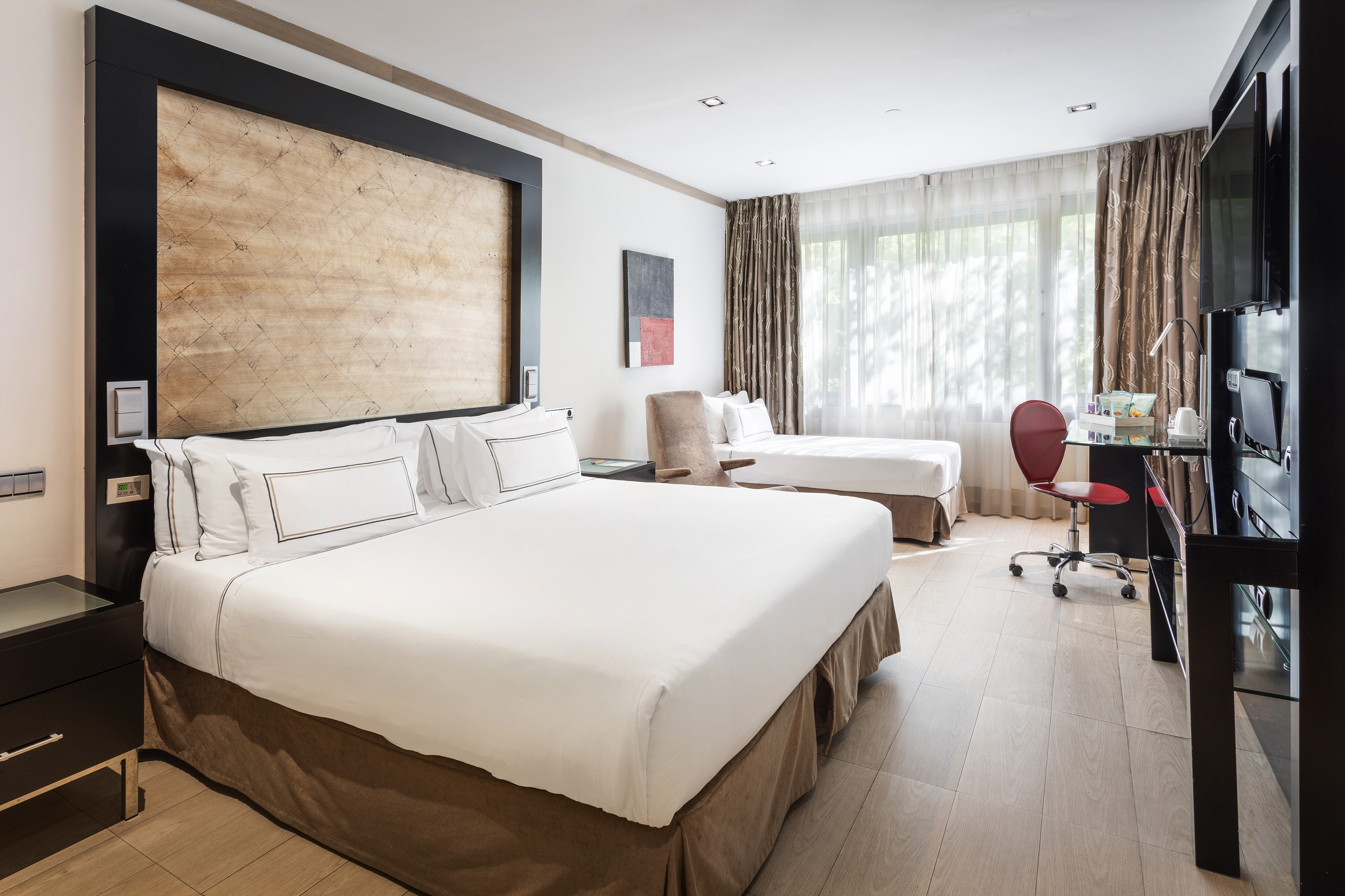 a room with two beds and a desk