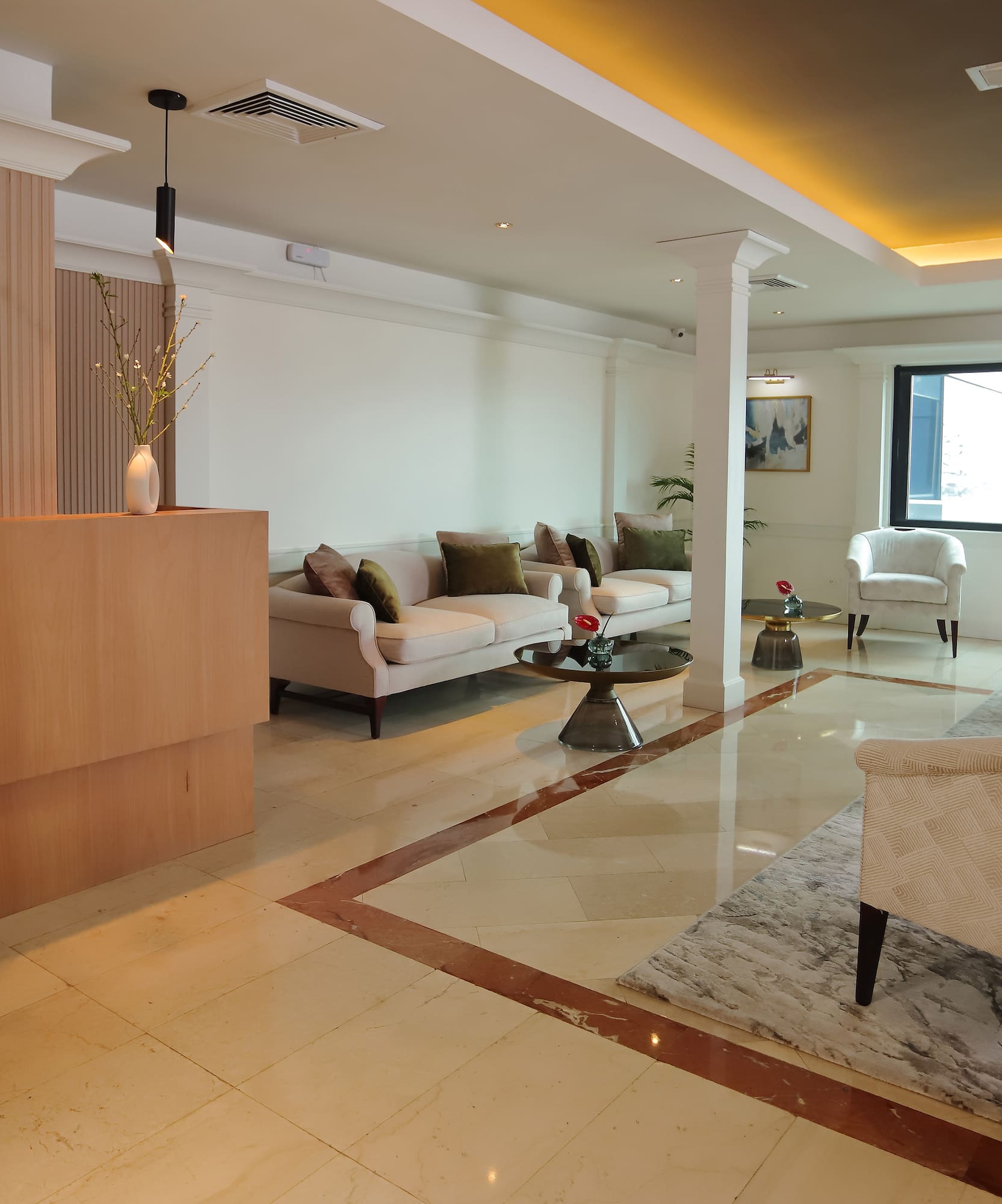 a room with a marble floor and white furniture