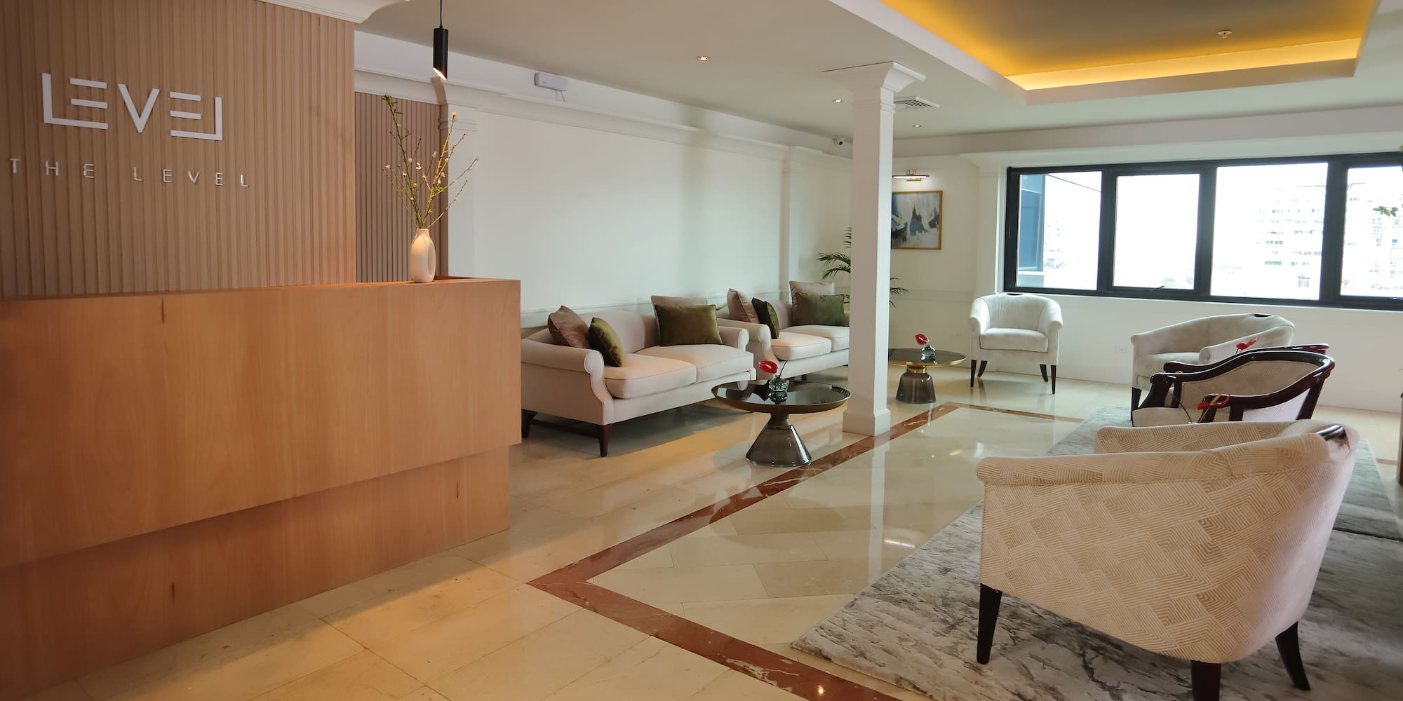 a room with a marble floor and white furniture