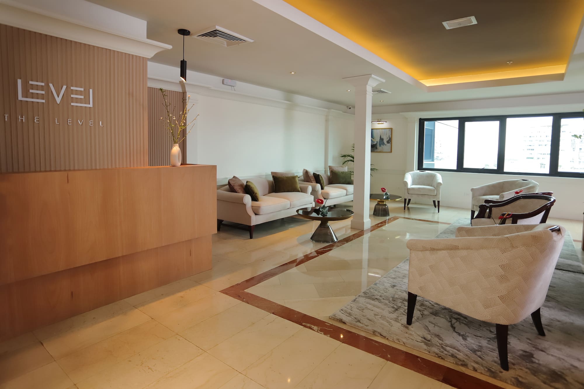 a room with a marble floor and white furniture