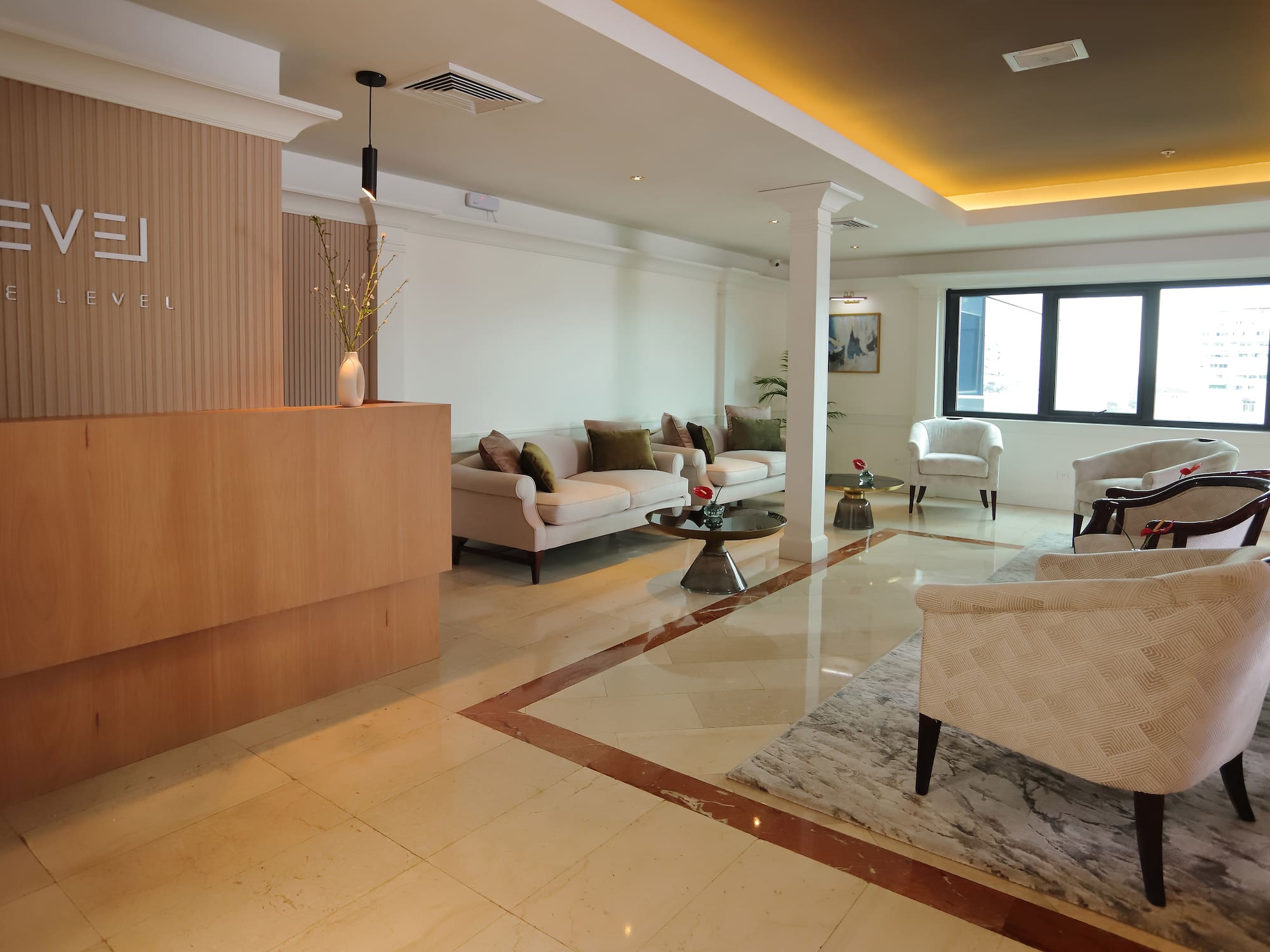 a room with a marble floor and white furniture