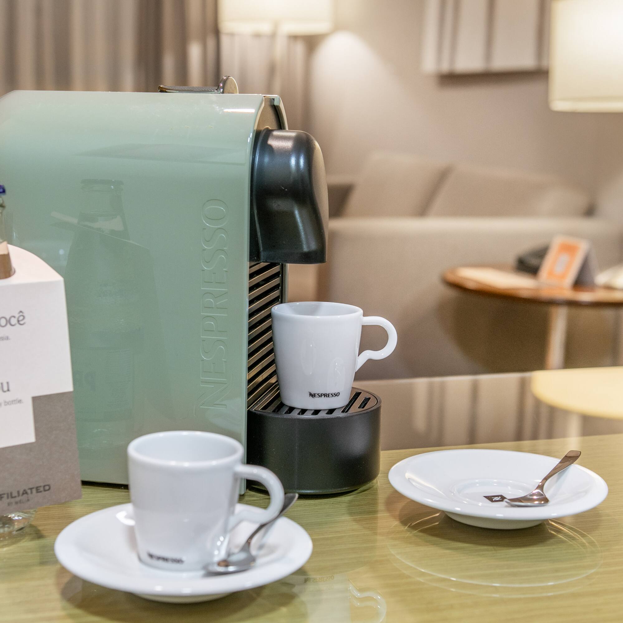 a coffee machine and cups on a table