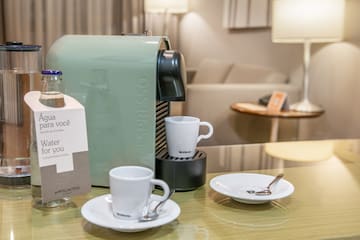 a coffee machine and cups on a table