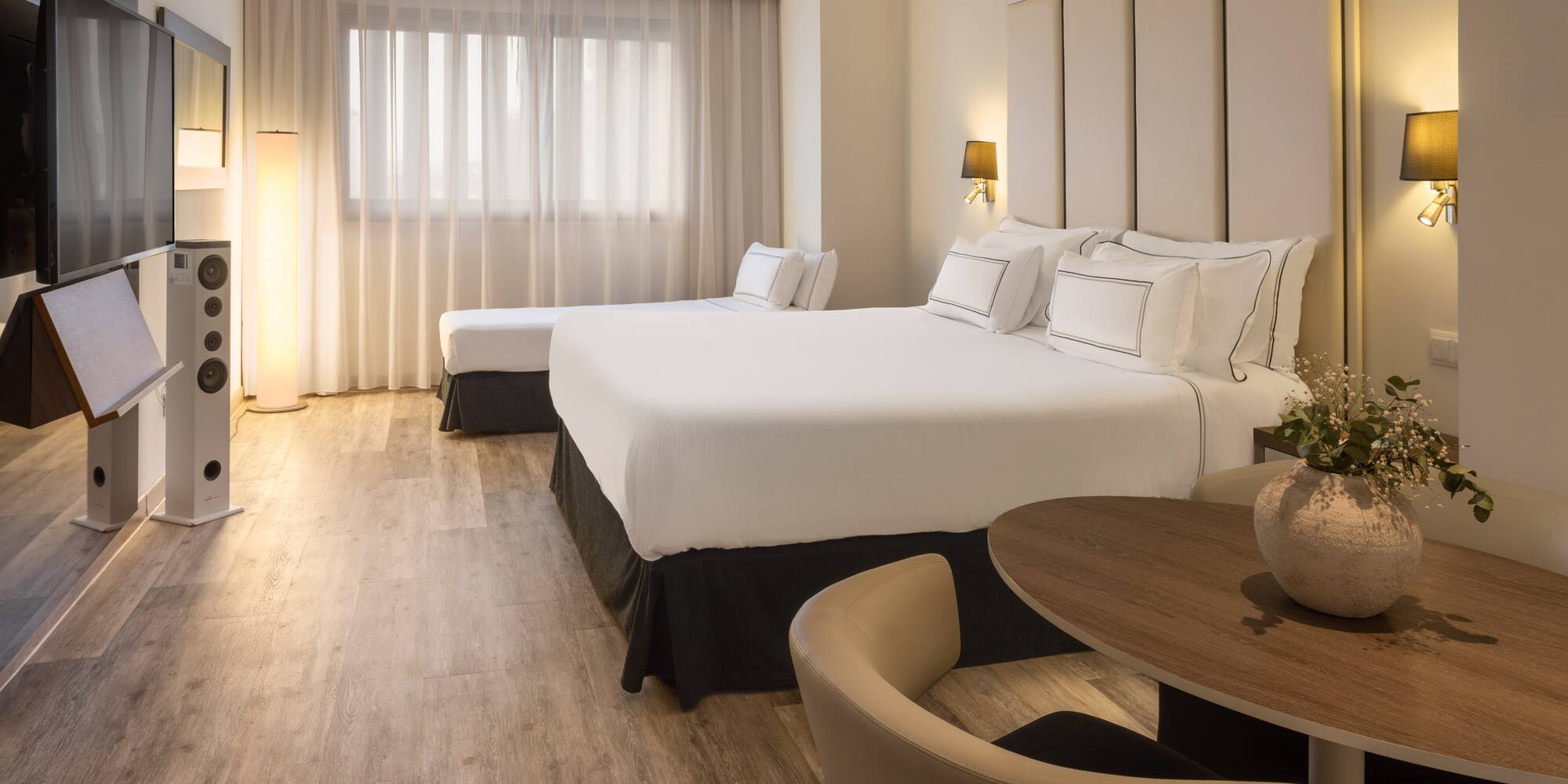 a room with two beds and a table