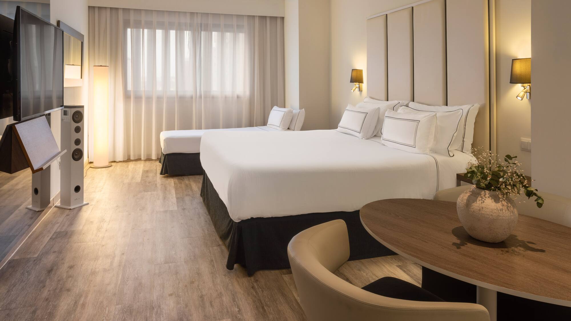 a room with two beds and a table