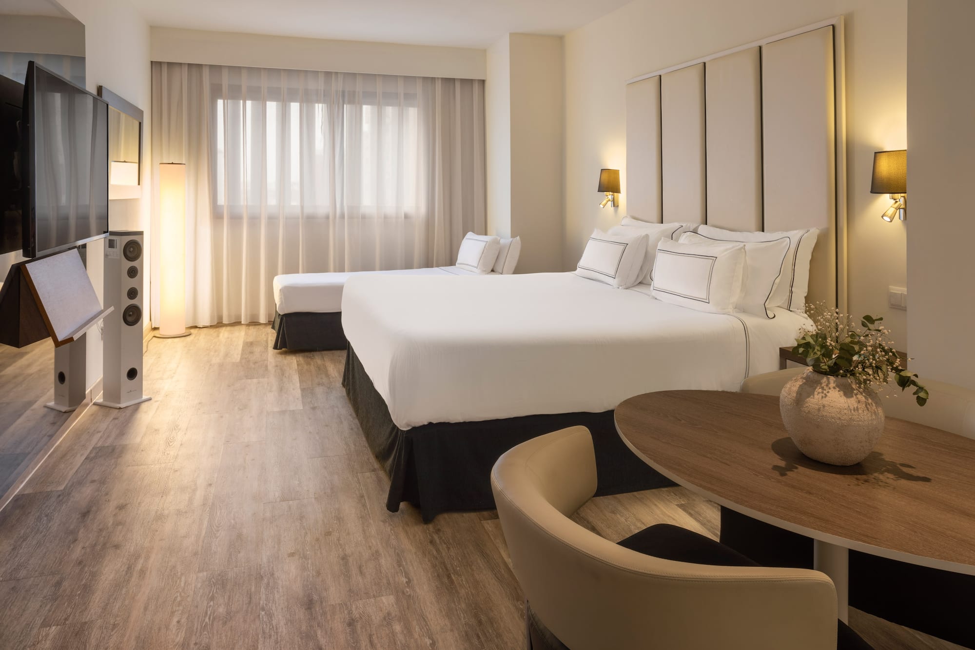 a room with two beds and a table