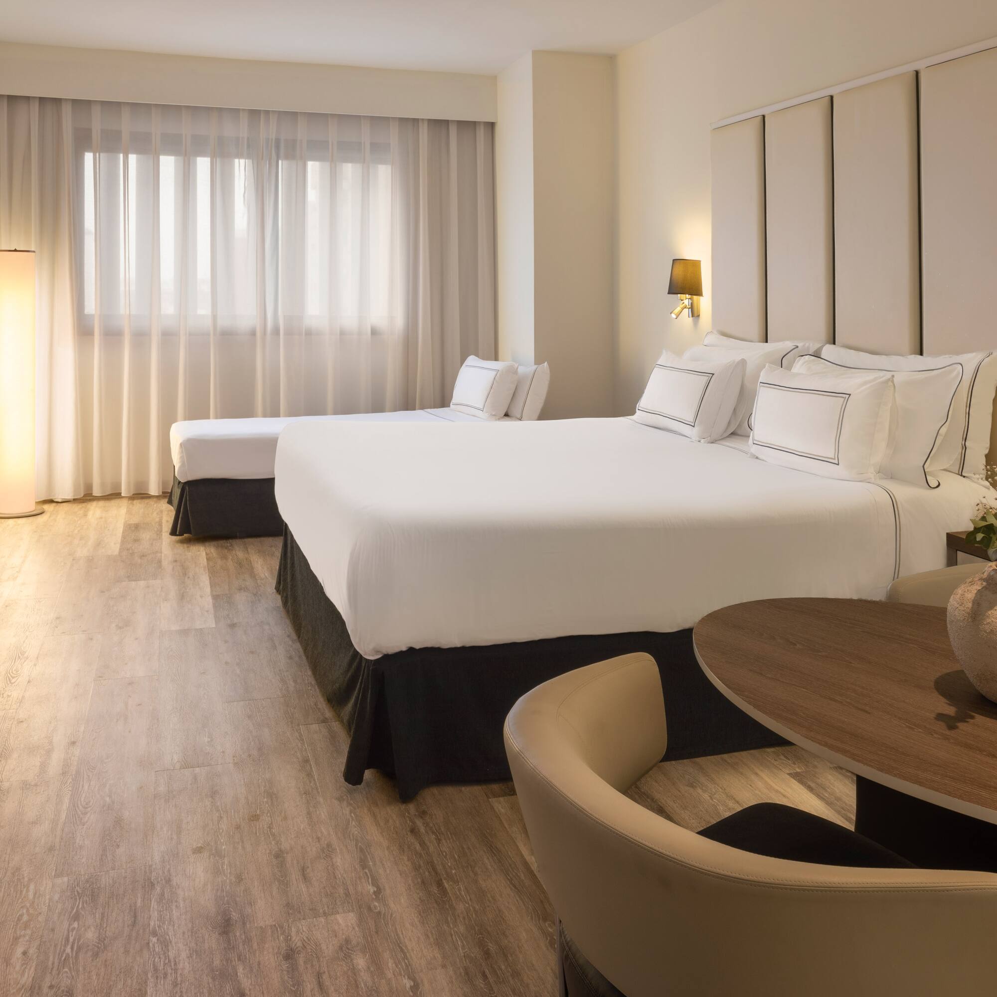 a room with two beds and a table