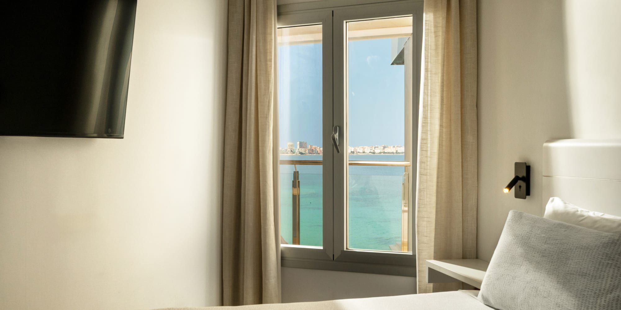 a room with a window and a bed