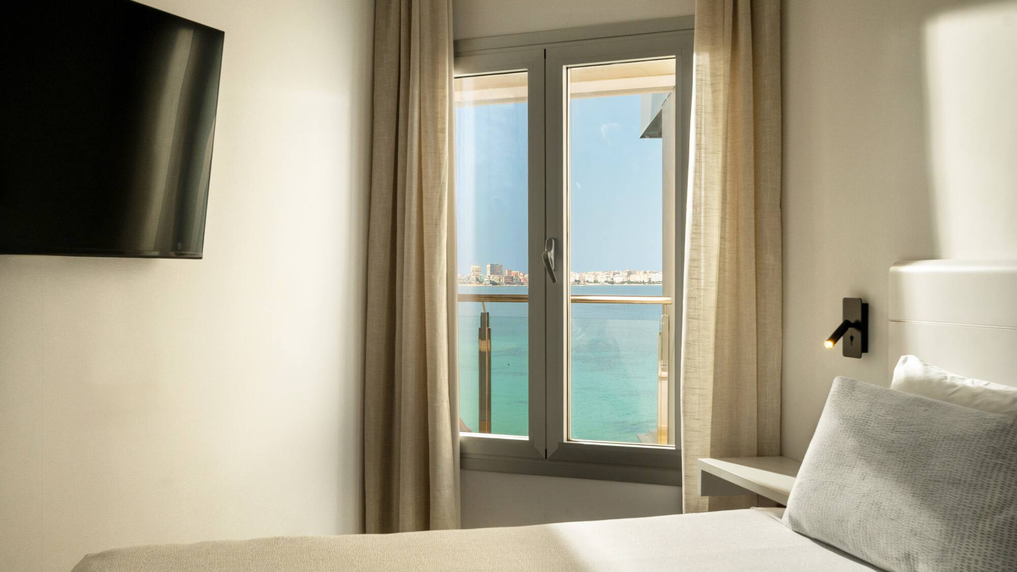 a room with a window and a bed