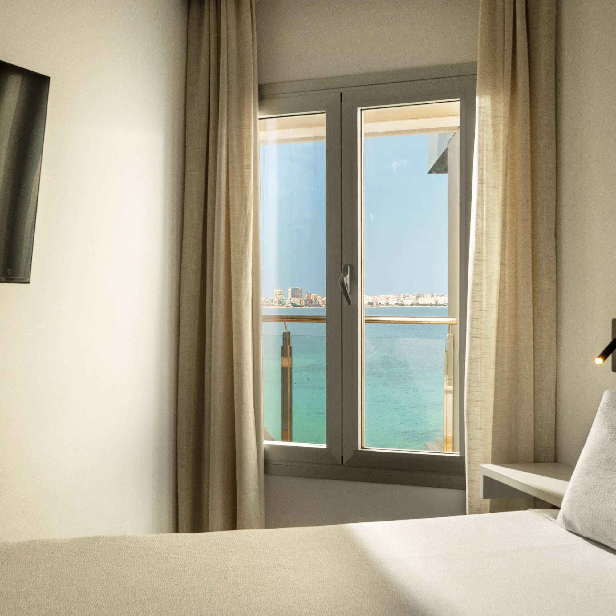 a room with a window and a bed