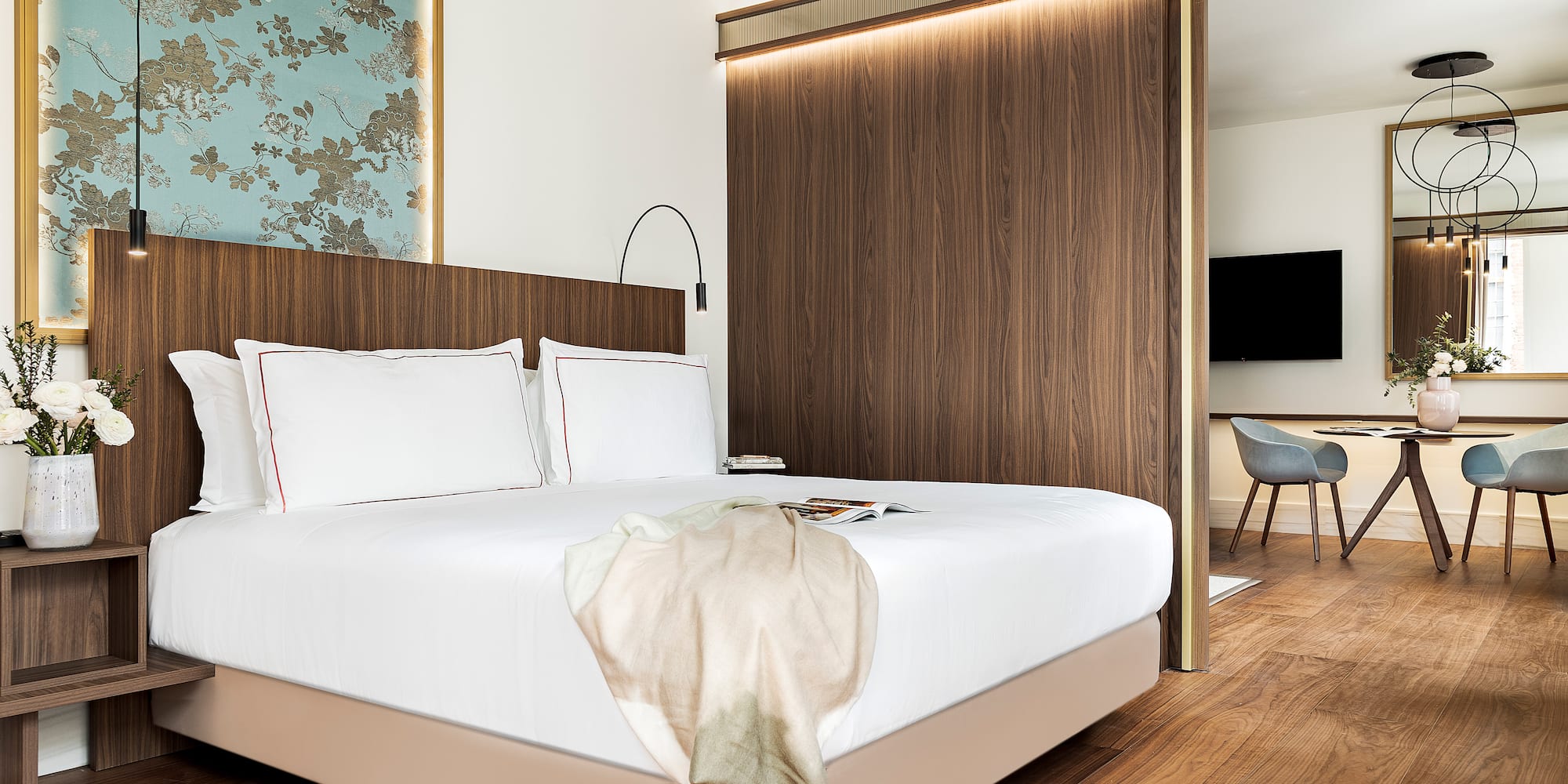 a bed with a wood paneled wall and a mirror