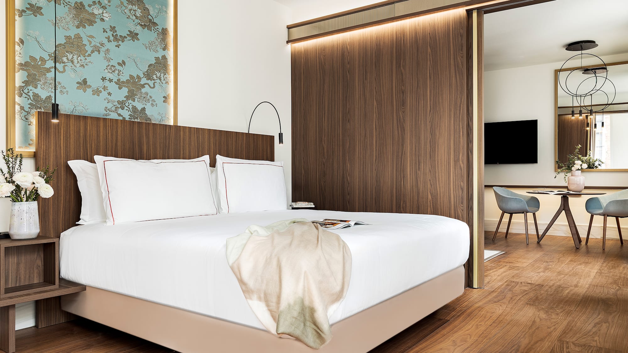 a bed with a wood paneled wall and a mirror