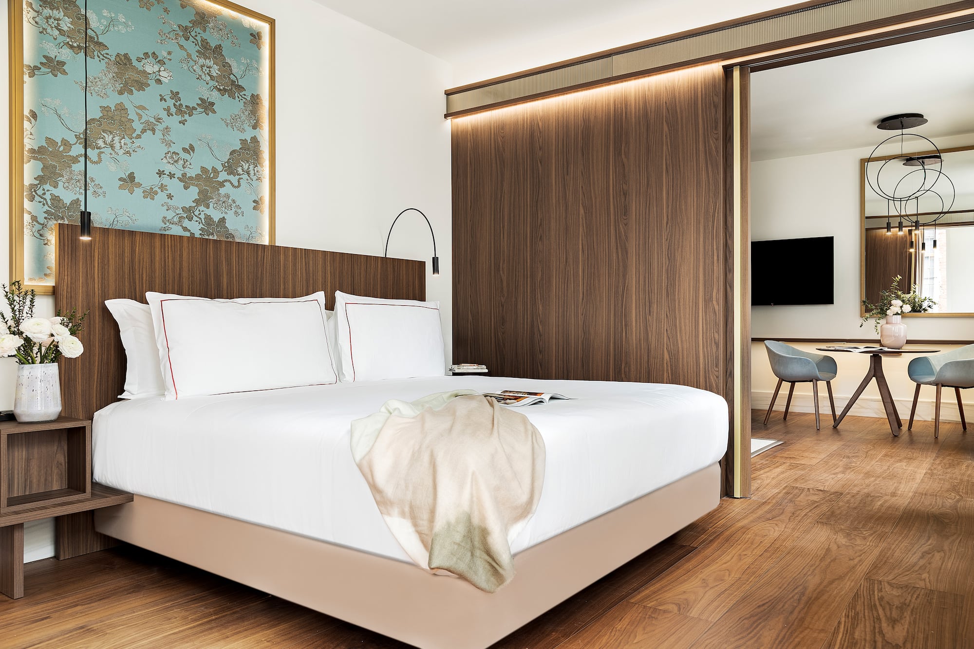 a bed with a wood paneled wall and a mirror