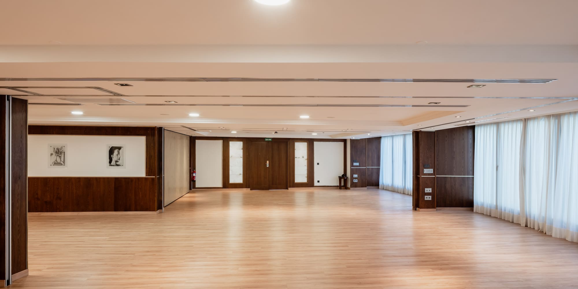 a large room with wood floors and white walls