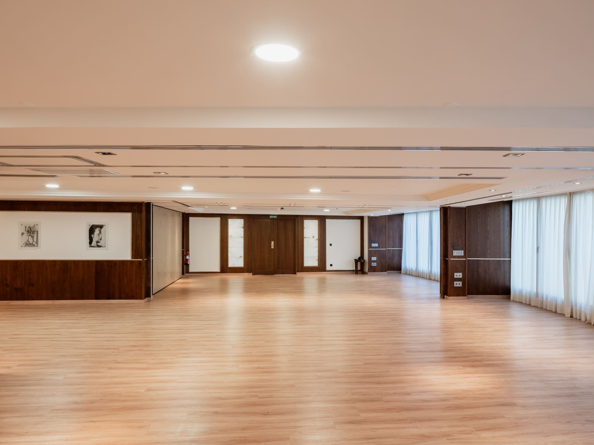 a large room with wood floors and white walls