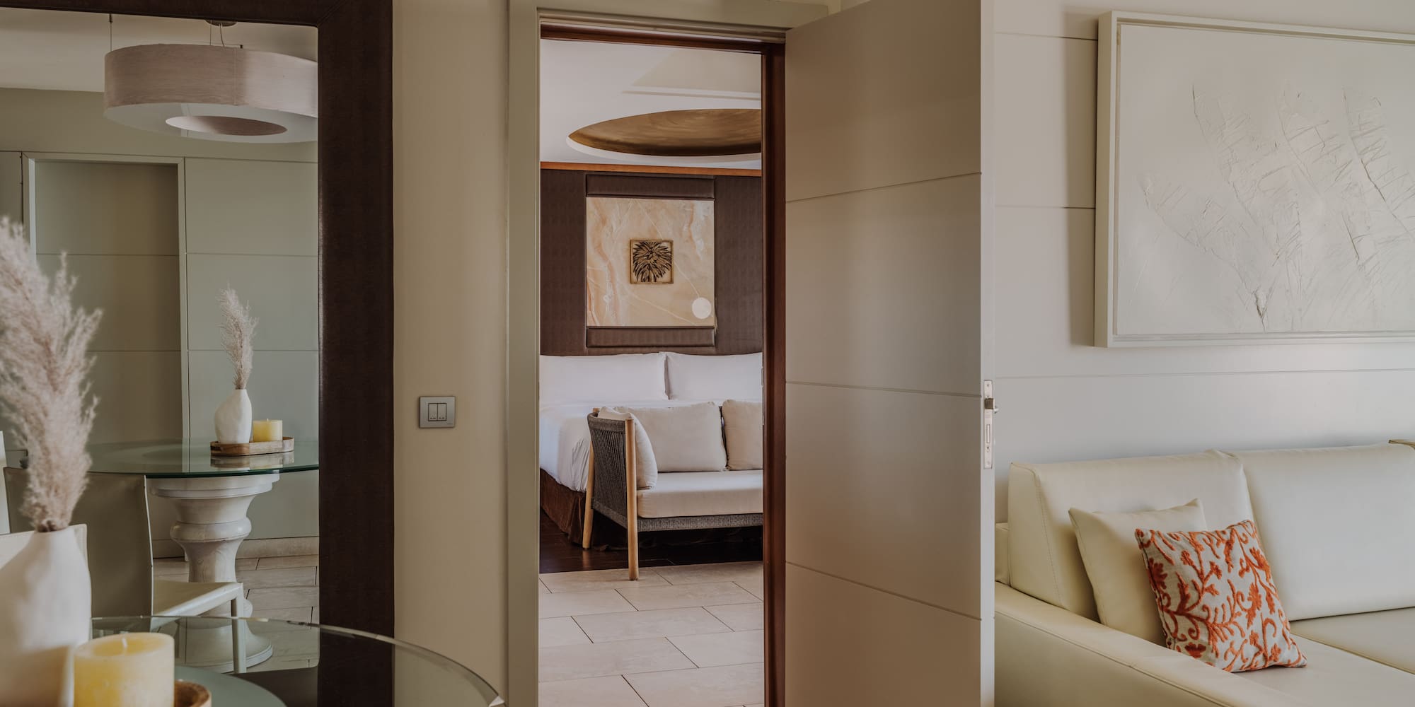 a room with a glass table and a couch