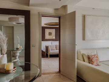 a room with a glass table and a couch