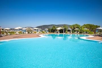 a pool with umbrellas and chairs