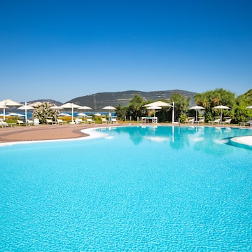 a pool with umbrellas and chairs