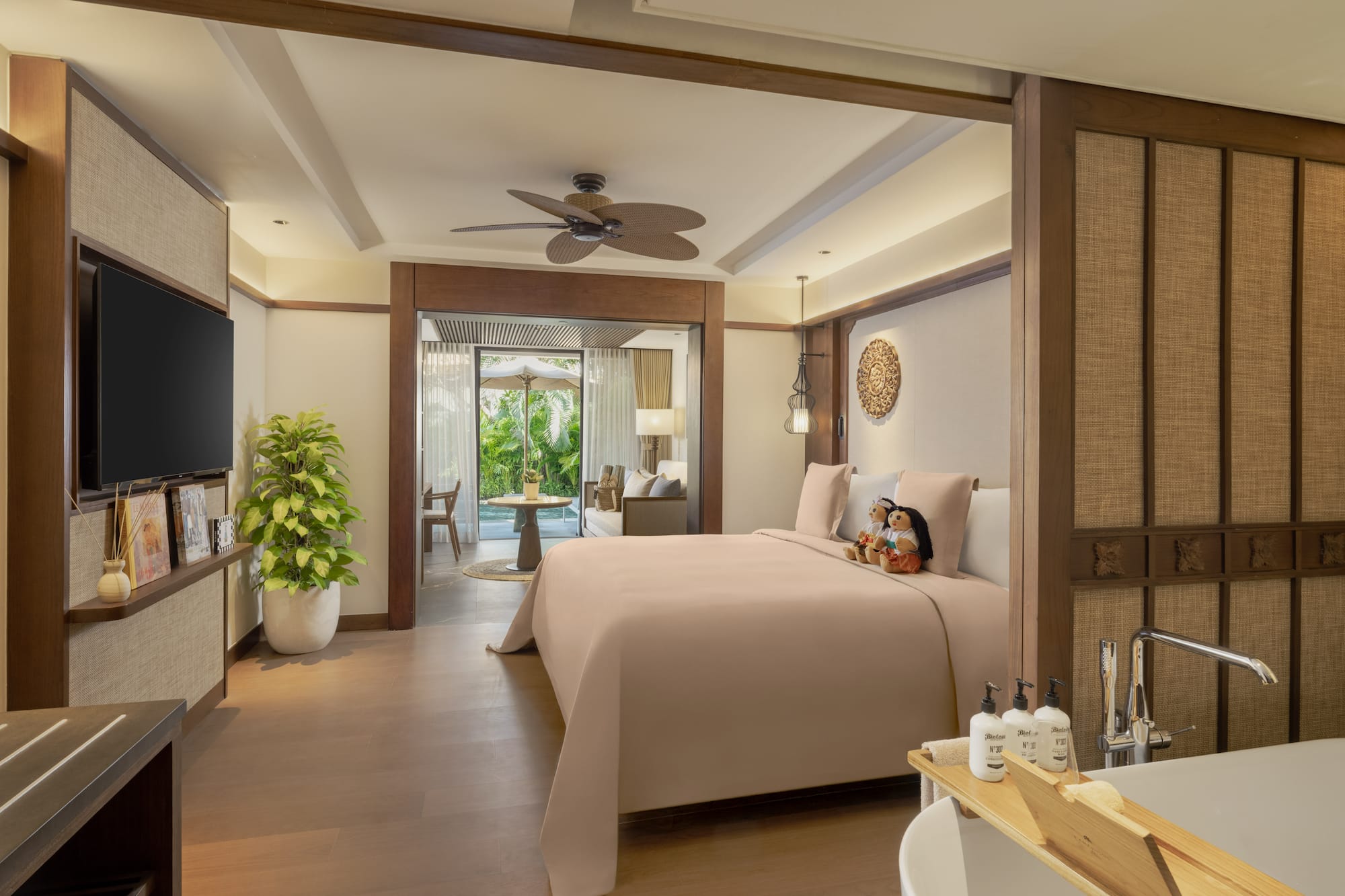 a bedroom with a television and a bathtub