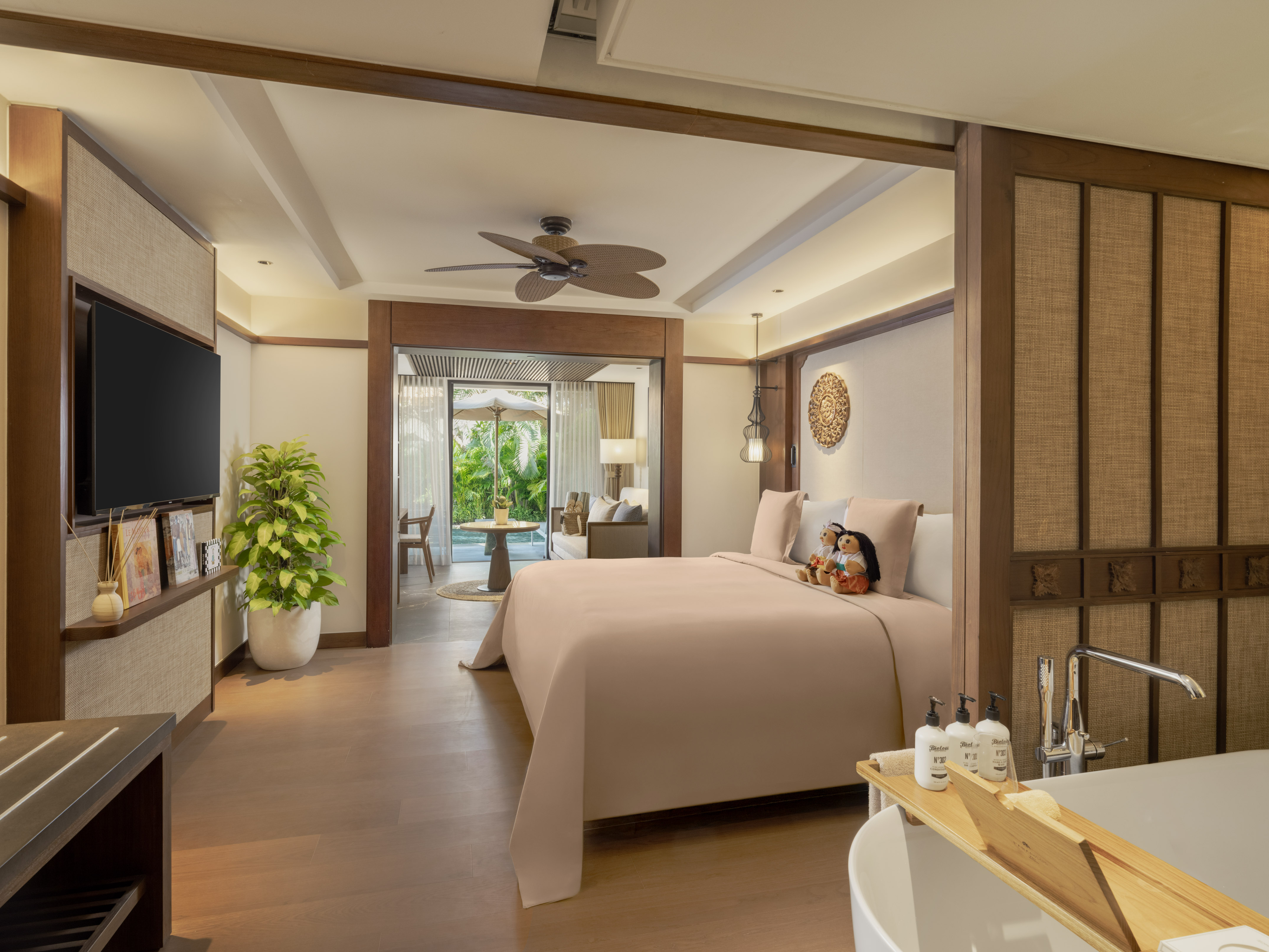 a bedroom with a television and a bathtub