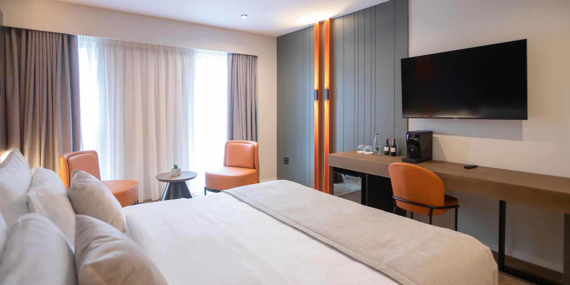 a room with a bed and a television