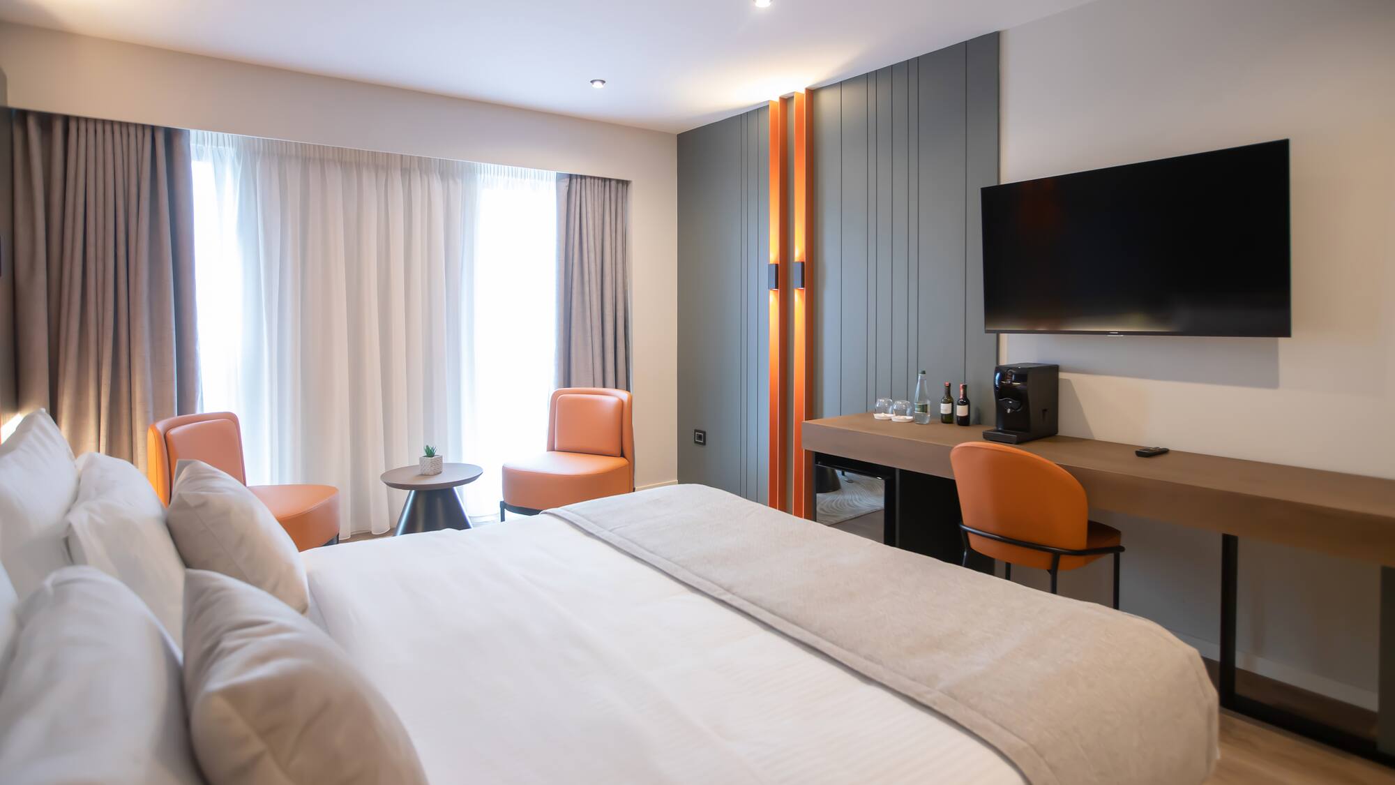 a room with a bed and a television